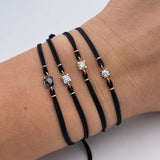 Bracciale punto luce nero in oro bianco su cordino-Bracciali-GRANARELLI-Gioielleria Granarelli